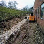 Excavator shaping new footpath formation during groundworks at York University Heslington Campus