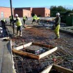 Concrete slab being poured and levelled during groundworks at York University Heslington Campus