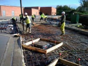 Concrete slab being poured and levelled during groundworks at York University Heslington Campus