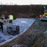 Operatives installing paving slabs during external works at York University Heslington Campus