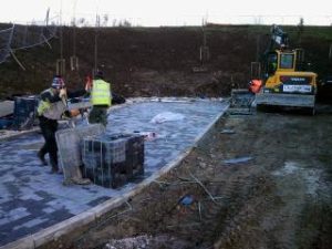 Operatives installing paving slabs during external works at York University Heslington Campus